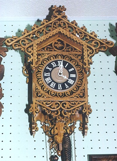 One of over two hundred antique and hand-carved wooden clocks displayed for enjoyment, not for sale.