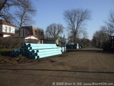 Pipes piled on Ash Street, Sauk Centre, Minnesota.