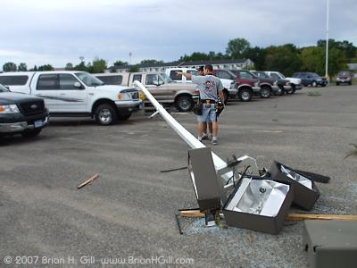 One light pole down, two guys making plans. Sauk Centre, Minnesota