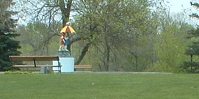 A statue of two kids under an umbrella: Summertime is back at Sinclair Lewis Park.